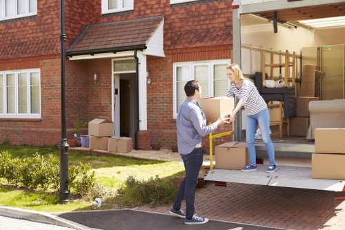 Office movers carrying boxes and desks with care